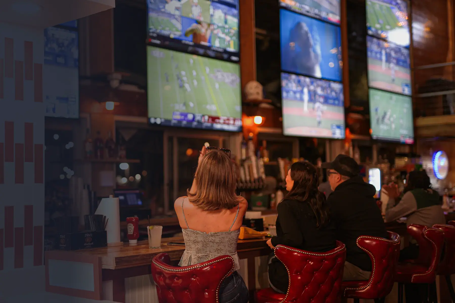 Tommy John's Tailgate sports bar interior with multiple TV screens